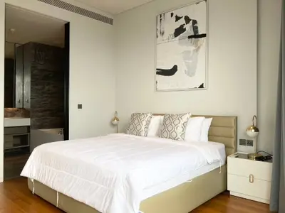 Luxurious bedroom with modern decor and elegant lighting in a high-end apartment.