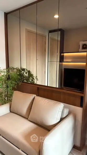 Modern living room with sleek design and mirrored wall panels