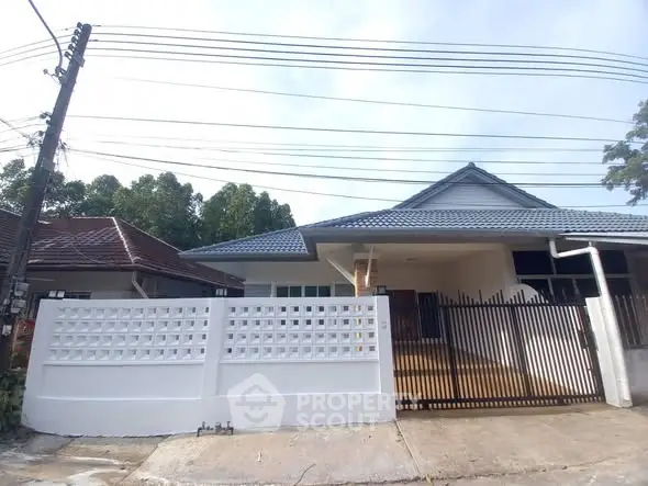 Charming single-story house with modern fence and spacious driveway in a serene neighborhood.