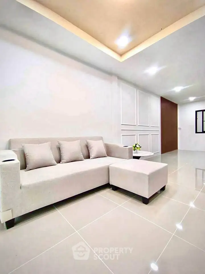 Spacious modern living room with elegant white sofa and sleek tile flooring