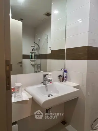 Modern bathroom with sleek sink and shower area in contemporary apartment