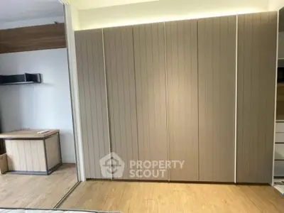 Modern storage space with sleek wooden cabinets and desk area