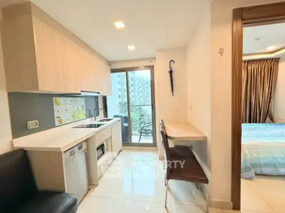 Modern kitchen with open layout and balcony view in stylish apartment