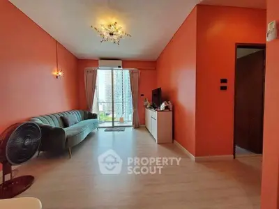 Spacious living room with modern decor and balcony view in vibrant apartment.