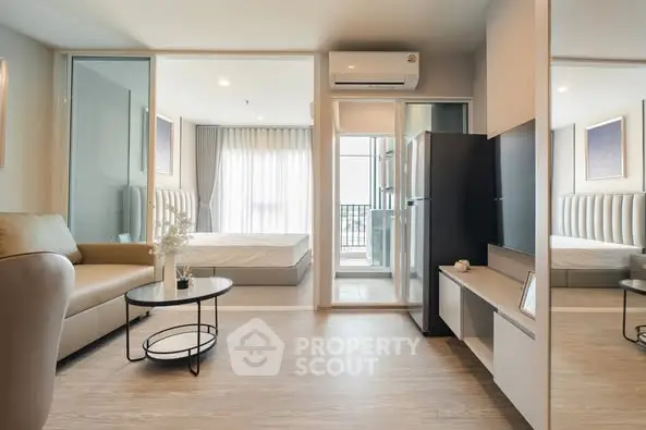 Modern open-plan living room with sleek furniture and balcony view