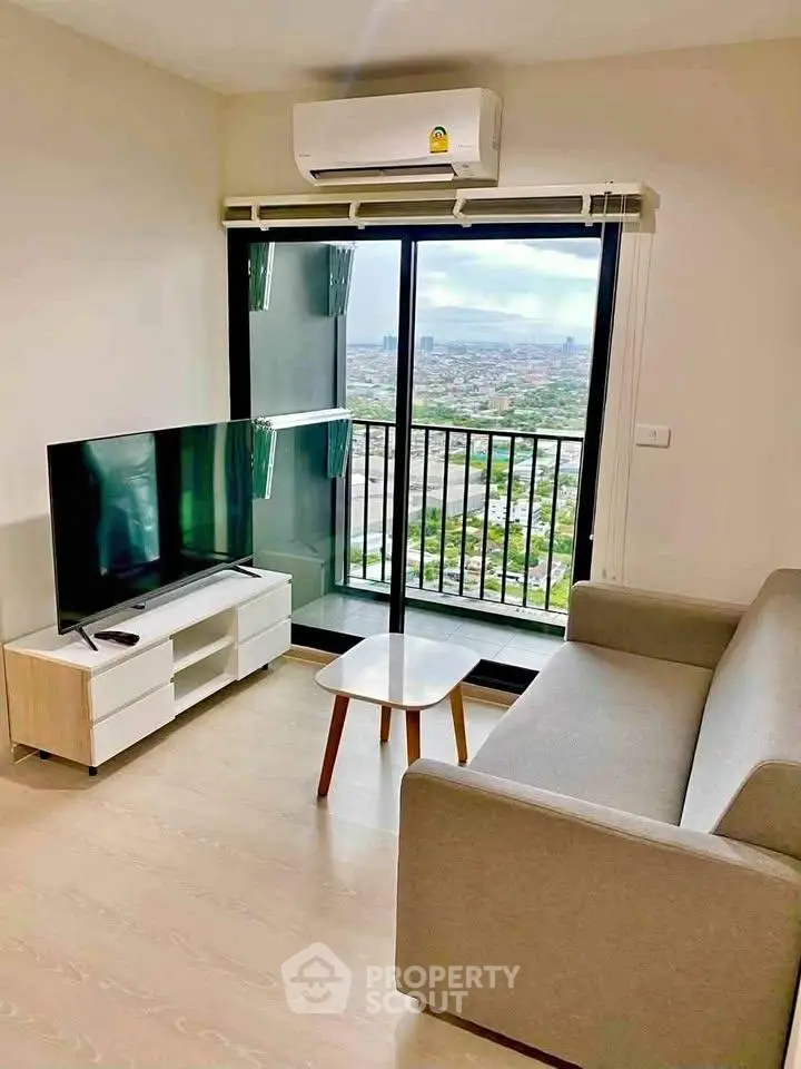 Modern living room with city view, featuring sleek furniture and large window for natural light.