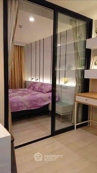 Modern bedroom with glass sliding doors and elegant decor