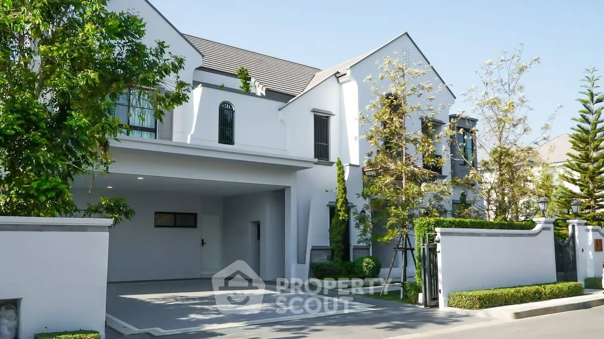 Elegant modern house exterior with lush greenery and spacious driveway