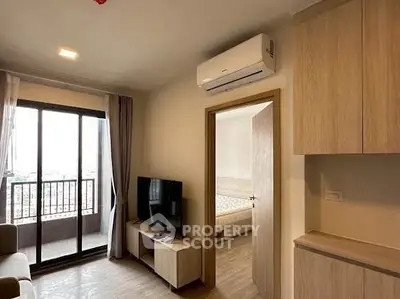 Modern apartment interior with balcony view, featuring air conditioning and stylish wooden furniture.