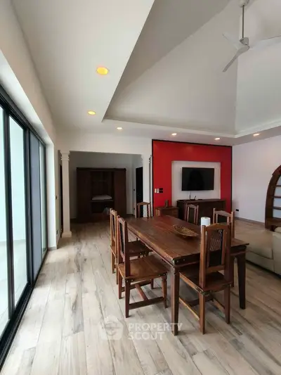 Spacious living room with elegant wooden dining set and modern decor