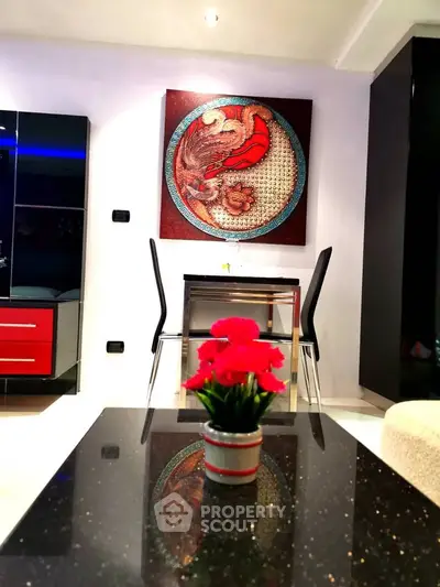Modern living room with stylish decor and sleek furniture, featuring a vibrant wall art piece and elegant table setting.