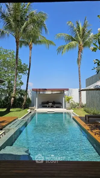 Luxurious tropical villa with private pool and lush garden, perfect for relaxation and leisure.