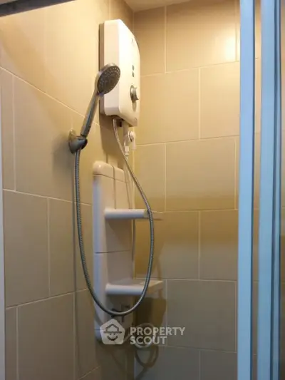 Modern bathroom with electric shower and tiled walls