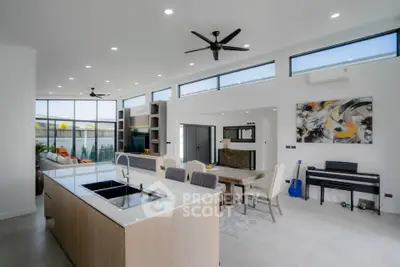Modern open-plan living room with kitchen island and stylish decor