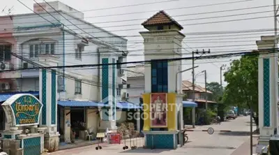Charming residential entrance with traditional architectural features and vibrant street view.