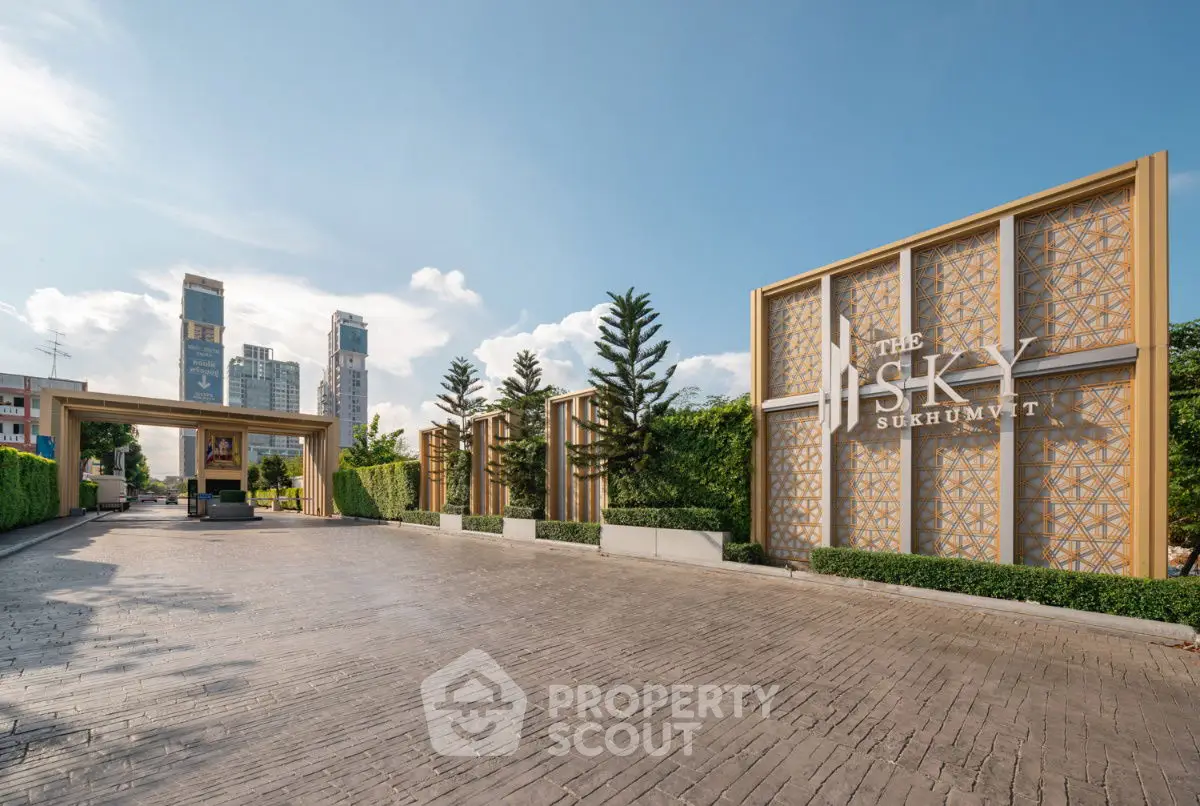 Luxurious entrance of The Sky Sukhumvit with modern architecture and lush greenery.