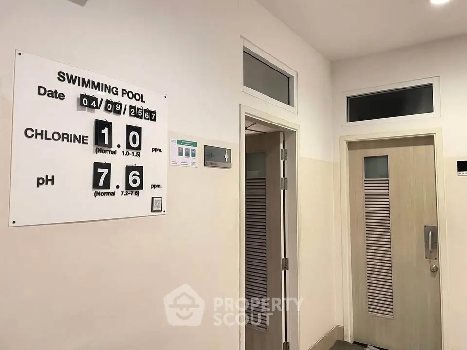 Modern swimming pool area with chlorine and pH level display, sleek doors, and contemporary design.