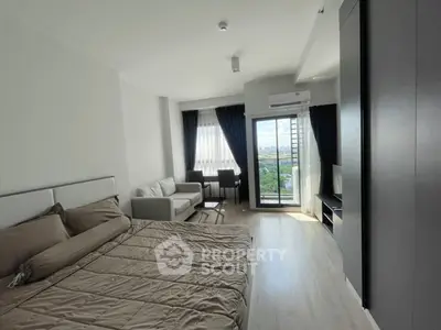 Modern studio apartment with balcony and scenic view, featuring cozy bed and stylish living area.