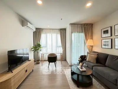 Modern living room with stylish decor and natural light, featuring a cozy sofa and elegant furnishings.