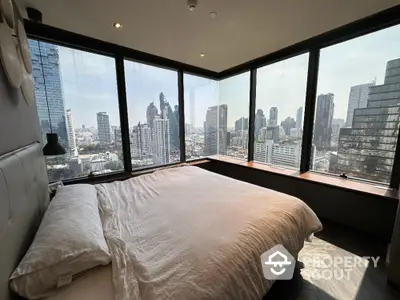 Luxurious bedroom with panoramic city view in high-rise apartment