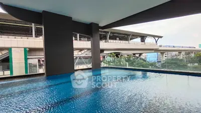 Luxurious rooftop pool with stunning city views, perfect for relaxation and leisure in a modern urban setting.