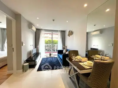 Spacious and modern living room with gleaming tiled floors, elegant dining setup, and cozy lounge area leading to a sunlit balcony.
