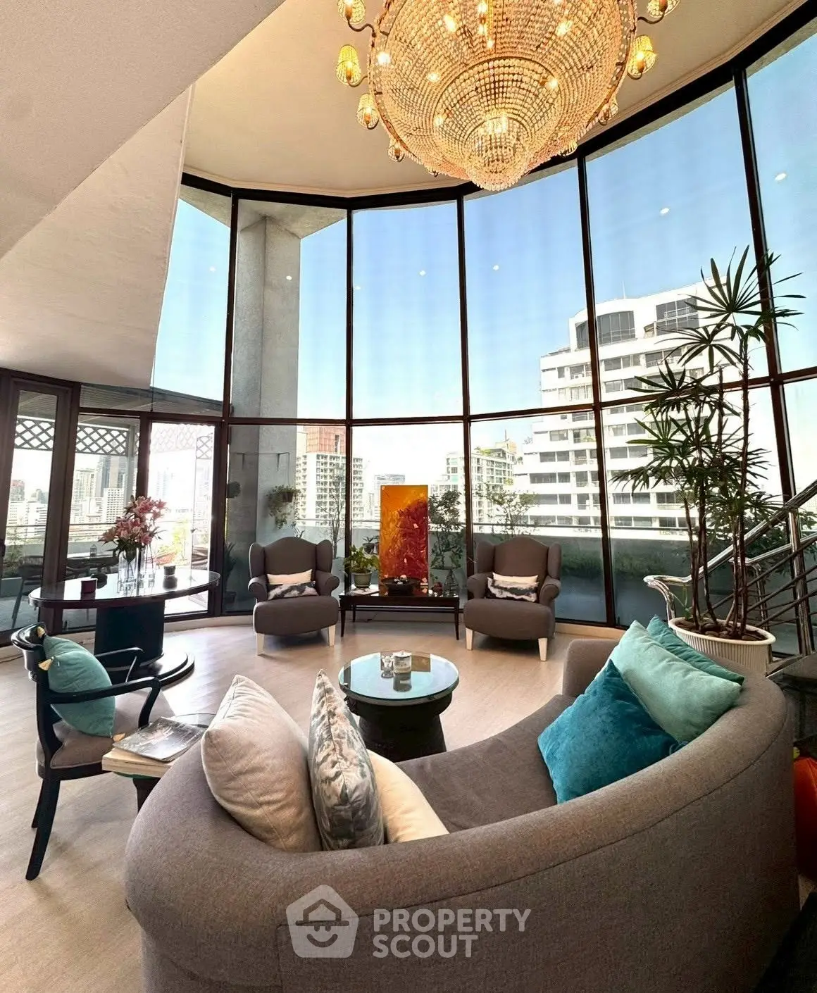 Luxurious living room with panoramic city views and elegant chandelier