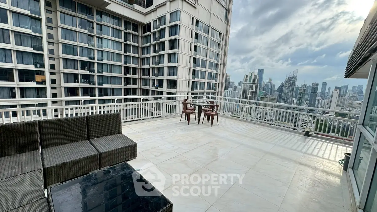 Spacious rooftop terrace with stunning city skyline views, perfect for outdoor relaxation and entertainment.