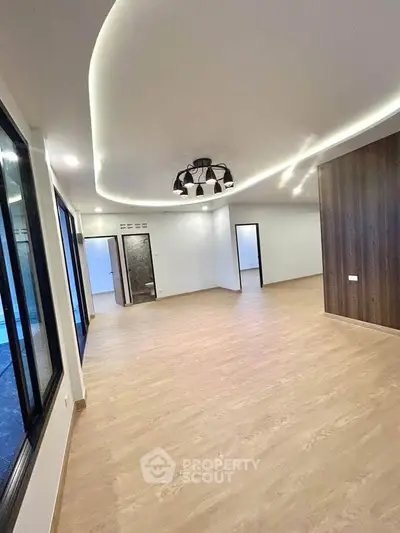 Spacious modern living room with elegant lighting and wooden flooring