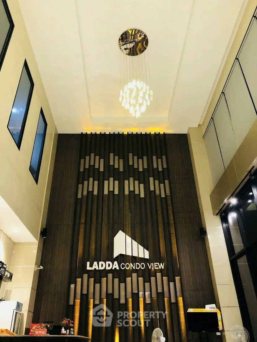 Elegant condo entrance with modern chandelier and high ceiling design