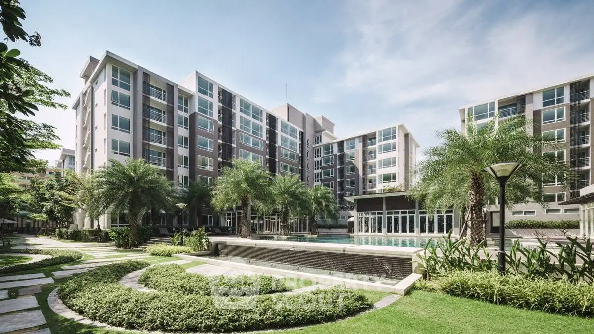 Modern apartment complex with lush landscaping and pool area