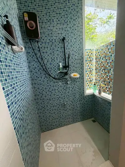 Modern bathroom with stylish mosaic tiles and natural light