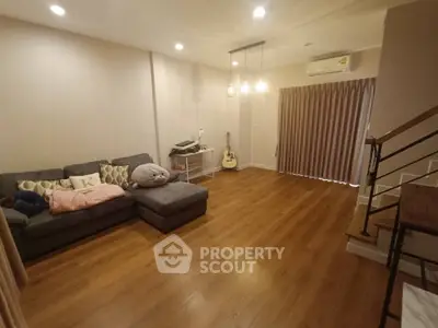 Spacious living room with cozy sectional sofa and modern lighting