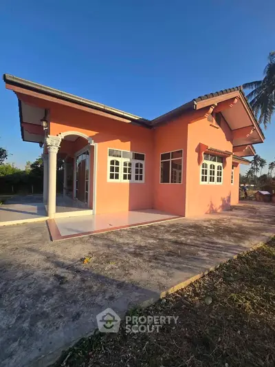 Charming single-story home with unique architectural design and spacious outdoor area.