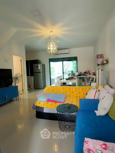 Spacious living room with modern decor and large windows offering natural light.