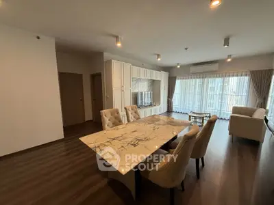 Spacious modern living room with elegant marble dining table and natural light