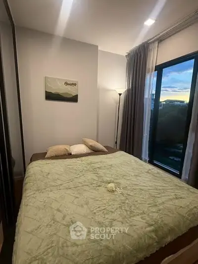 Cozy bedroom with large window and scenic view, featuring a comfortable bed and modern decor.