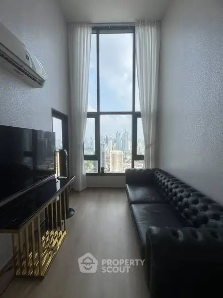 Luxurious living room with stunning city view and elegant black leather sofa
