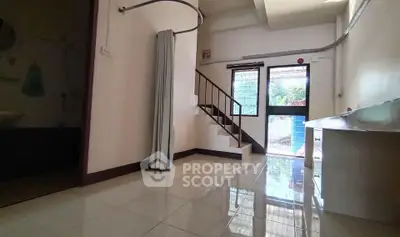 Spacious interior with tiled flooring and staircase, ideal for modern living.