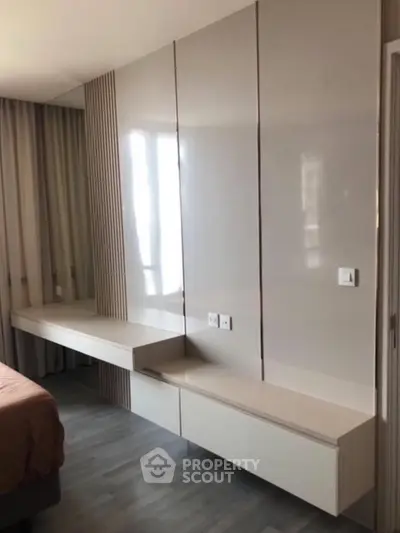 Modern bedroom with sleek built-in storage and elegant design