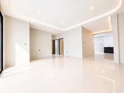 Spacious modern living room with sleek tile flooring and recessed lighting