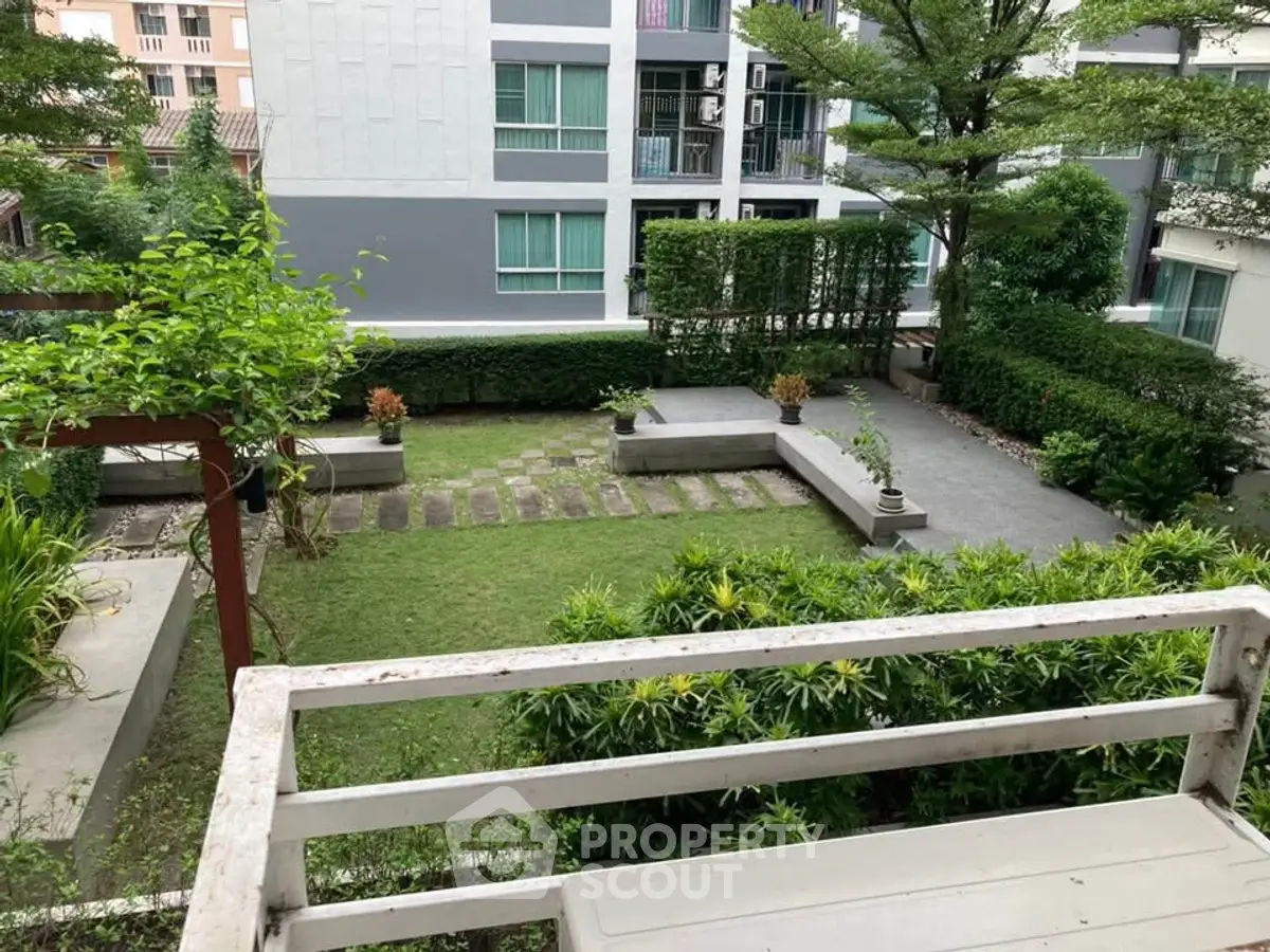 Charming garden view from balcony in modern residential complex
