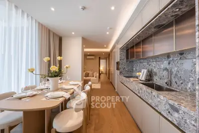 Luxurious open-layout kitchen and dining area with elegant decor and modern appliances.