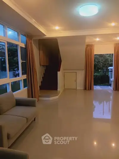 Spacious living room with modern design and large windows for natural light.