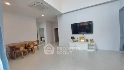 Spacious modern living room with dining area and wall-mounted TV