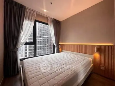 Modern bedroom with large window and stylish lighting in urban apartment