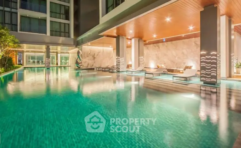 Luxurious apartment complex with stunning pool and modern design.