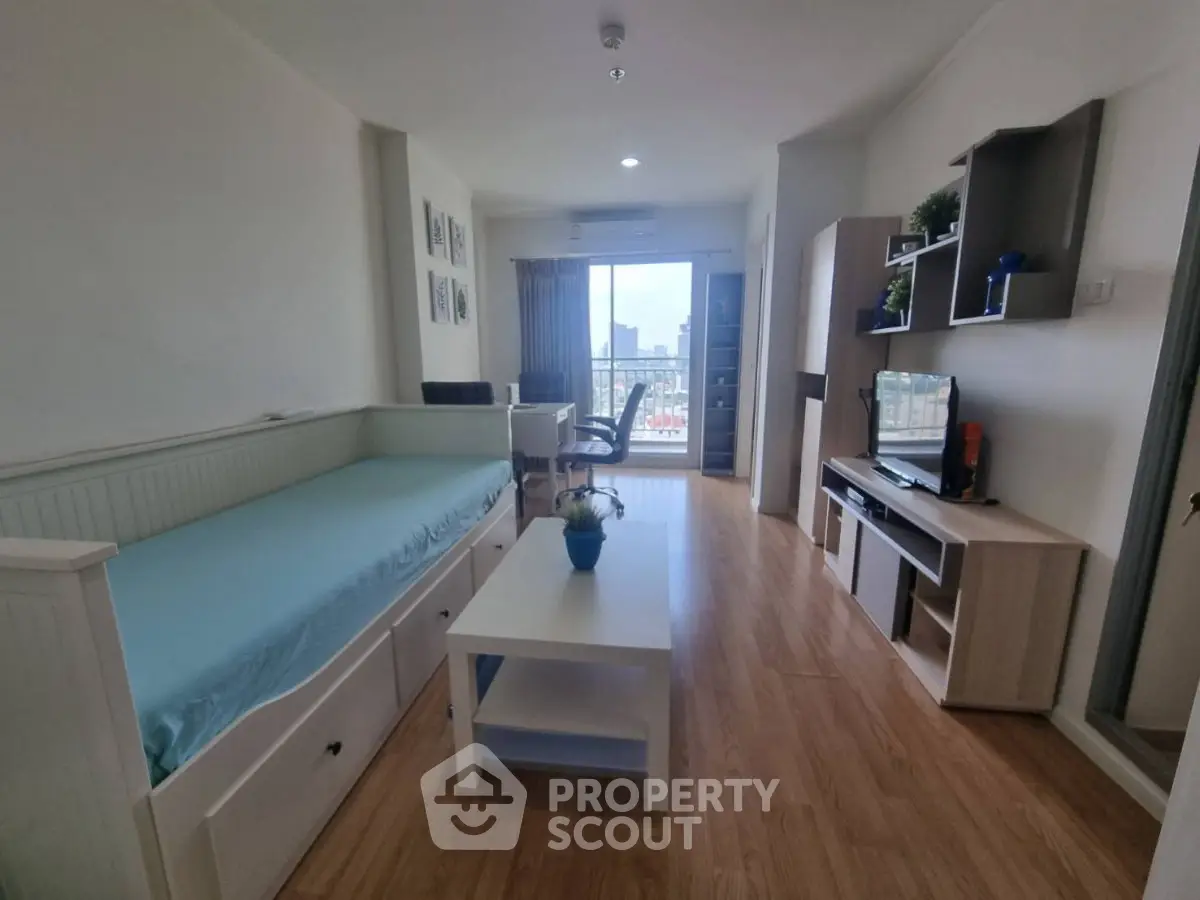 Modern living room with wooden flooring, stylish furniture, and a city view from the balcony.