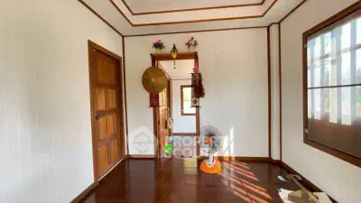 Charming hallway with wooden doors and natural light, perfect for cozy living.