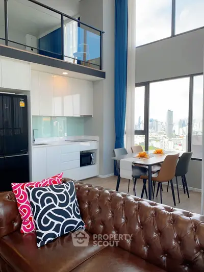 Modern loft apartment with city view, featuring stylish kitchen and cozy living area.